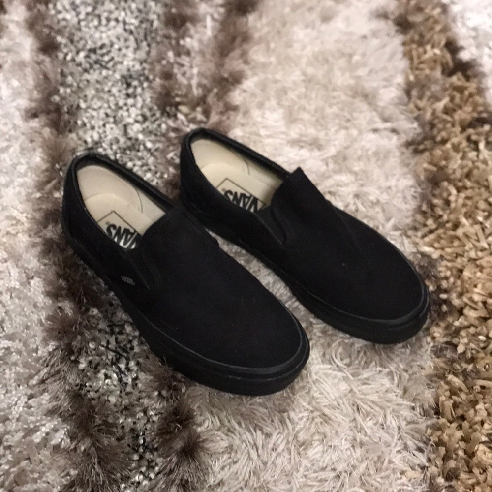 Black on black slip on vans